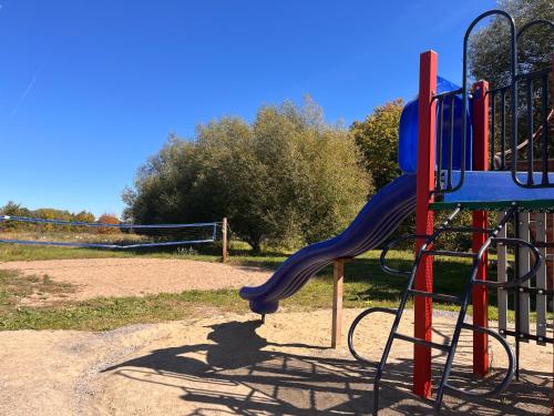 a playground with a slide in a park at Camping Chalets Lac St-Augustin in Quebec City