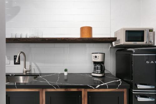 a kitchen with a black refrigerator and a microwave at La Ventana in San Diego