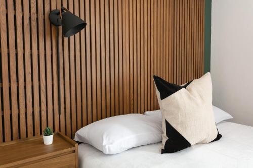 a bed with a pillow and a wooden headboard at La Ventana in San Diego