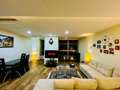 a living room with a couch and a fireplace at Centaurus Services apartment, luxury studio apartment in Islamabad