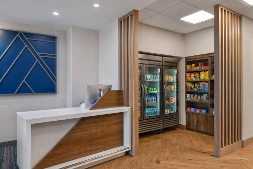 a pharmacyacist with a counter and a refrigerator at Holiday Inn Express- North Palm Beach and IHG Hotel in Juno Beach