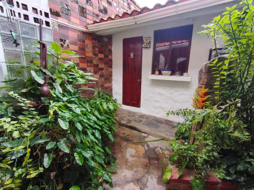 a house with a red door and some plants at Las Catalinas Anton Panama in Antón
