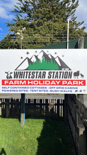 a sign for a white star station farm holiday park at White Star Station Farm Holiday Park in Coromandel Town