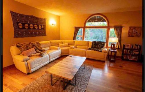 a living room with a couch and a table at Cheerful 3 bedroom home nestled in the redwoods in Trinidad