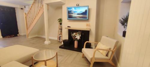 a living room with a chair and a fireplace at Modern two bedroom home in the heart of Dundalk in Dundalk