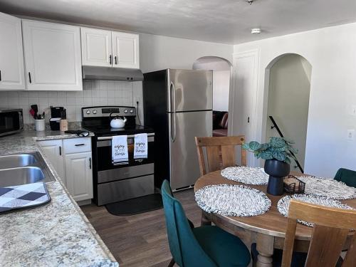 a kitchen with a table and a kitchen with a refrigerator at Mendon Oasis in Woonsocket