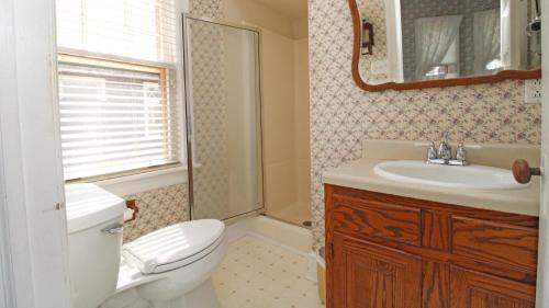 a bathroom with a toilet and a sink at Saltwood House 4 Bedroom in Cape May