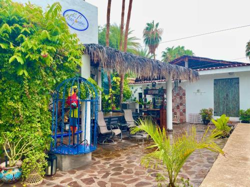 a house with a blue gate in a yard at Villas del Santo Niño in Loreto