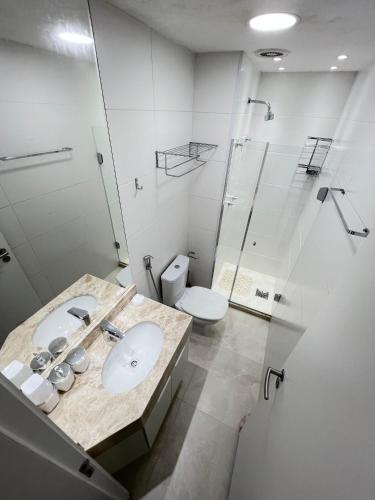 a bathroom with a sink and a shower and a toilet at Mar dos Anjos in Arraial do Cabo