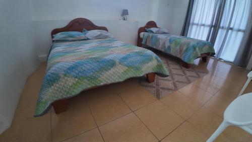 Postel nebo postele na pokoji v ubytování Hostal Neptuno - Poseidon