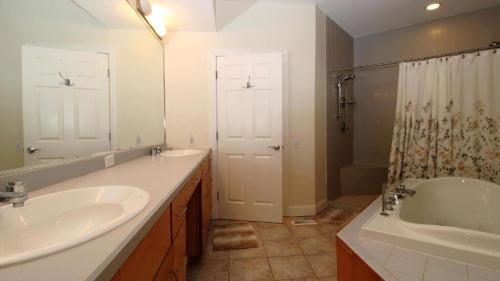 a bathroom with two sinks and a tub and a shower at 516 Mistletoes In The Sand, Cape May Beach in Villas