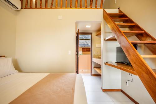 a small bedroom with a bed and a staircase at Villa das Palmeiras Jeri in Jericoacoara