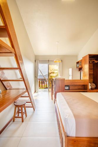 a bedroom with a large bed and a desk at Villa das Palmeiras Jeri in Jericoacoara