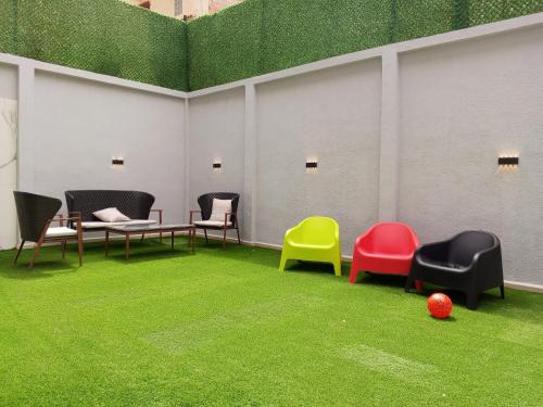 a room with chairs and a table and grass at Résidence touristique marcadal in Fort de lʼEau