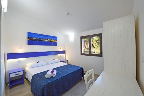 a hotel room with a bed and a window at Podere San Luigi Residence in Otranto