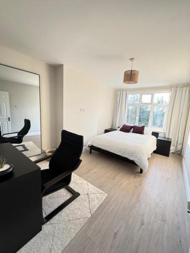 a bedroom with a bed and a desk and a mirror at Twos Company in Brookmans Park