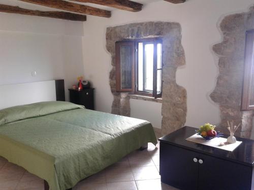 a bedroom with a bed and a table and a window at Apartment Bella Vista 2 in Buzet