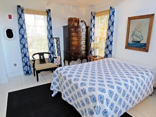 a bedroom with a bed with a blue and white bedspread at 418 Elmira Street in Cape May