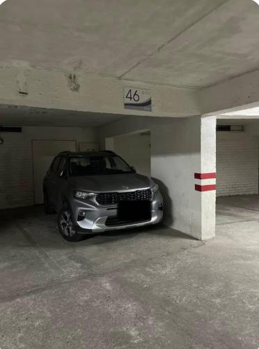 a silver car parked in a parking garage at Vista Infinita en Playa Cochoa in Concón