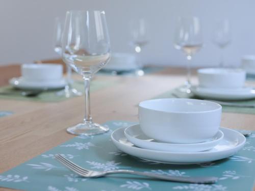 a table with a bowl and a plate and a glass at The Castle in Tokyo