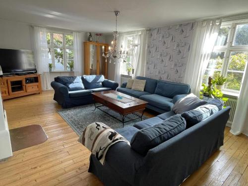 a living room with blue couches and a table at 10 person holiday home in Mörbylånga-By Traum in Mörbylånga