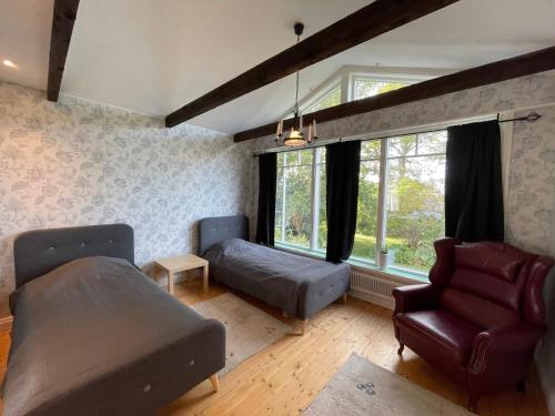 a bedroom with a bed and a couch and a chair at 10 person holiday home in Mörbylånga-By Traum in Mörbylånga
