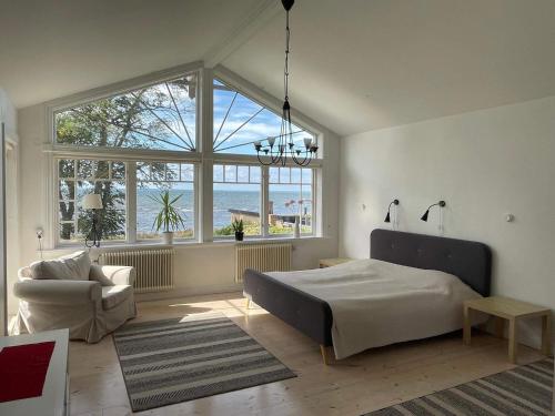 a bedroom with a bed and a couch and windows at 10 person holiday home in Mörbylånga-By Traum in Mörbylånga