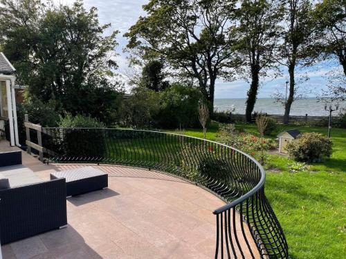a metal bench sitting on a patio near the water at 10 person holiday home in Mörbylånga-By Traum in Mörbylånga