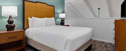 a bedroom with a large white bed and two lamps at Worldmark Kapaa Shore in Kapaa