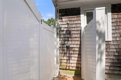 a white fence in front of a house at Classic Cape Great Location Dog Welcome in Wellfleet