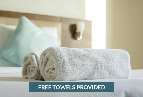 a pile of towels on top of a bed at 8045 - Mirlo Hi in Rodanthe