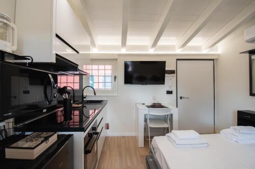a kitchen with a black counter top and a table at La Casetta Intimità e Relax tra Verona e Mantova in Mozzecane