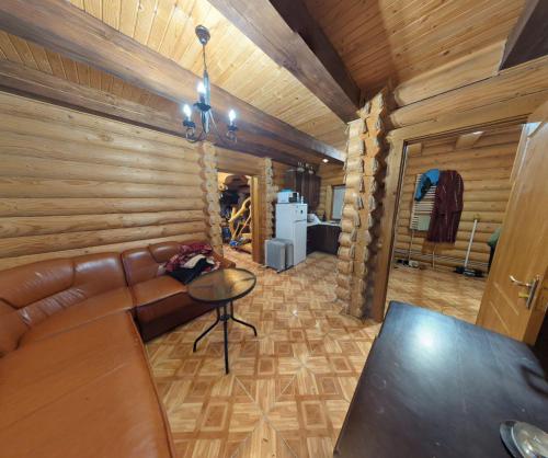 a living room with a couch and a table at Мʼята in Mykulychyn