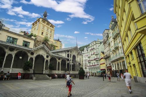a group of people walking down a city street at Spa Hotel Purkyně in Karlovy Vary