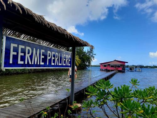 a sign on a pier next to a body of water at Villa MATOANUI in Tevaitoa