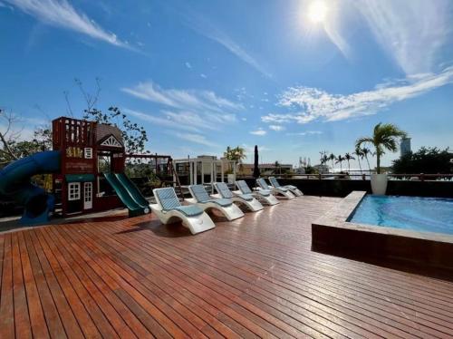 a playground with a slide and a swimming pool at Deck12 Casino and Resort by Monyxbnb in Puerto Vallarta