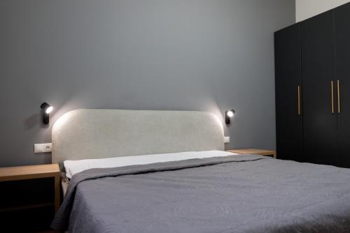 a bedroom with a large bed and a black cabinet at Mukhrani Villa Private Pool Near Tbilisi in Mukhrani