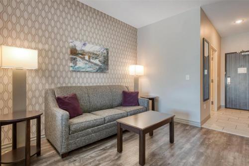 a living room with a couch and a table at Best Western Plus Saint Peter in Saint Peter