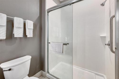 a bathroom with a toilet and a glass shower at Best Western Plus Saint Peter in Saint Peter