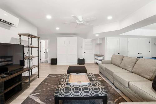 a living room with a couch and a table at Modern Wellfleet Retreat with Stunning Outdoor Spaces in Wellfleet