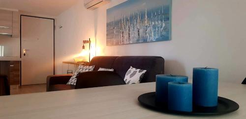 two blue candles on a table in a living room at La Terrazza sul Lago di Como con garage in Blevio