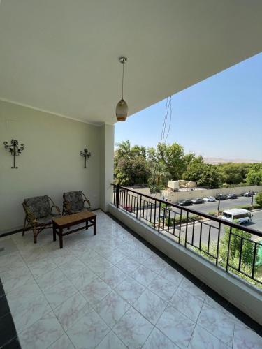 a balcony with a bench and a view of a street at Rezeiky Hotel & Camp in Luxor