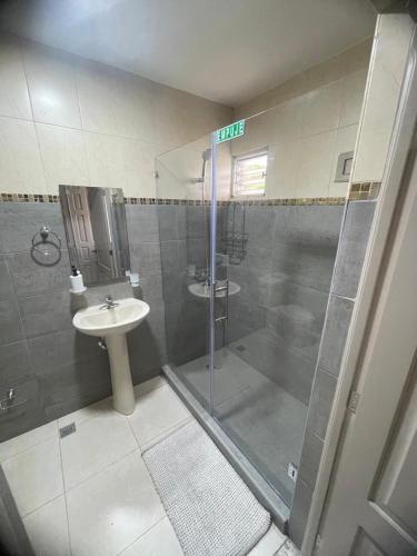 a bathroom with a shower and a sink at Hostal FT Santiago Stay in Santiago de los Caballeros
