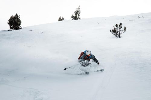 a person is skiing down a snow covered slope at Barthe Holidays I Apartamento céntrico en Andorra 6PAX I Ideal grupo o familia, a 1 min de Caldea I Perfección in Escaldes-Engordany