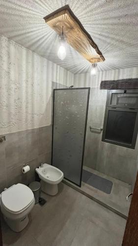 a bathroom with a toilet and a sink at Terrazas Suite in Potrero de Garay