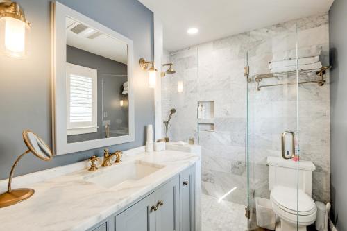 a bathroom with a sink and a toilet and a shower at Pool and Stunning Water Views Kent Island Home! in Stevensville