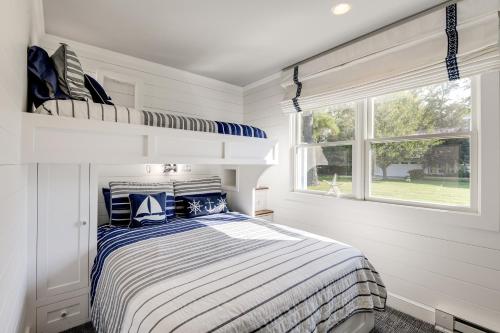 a white bedroom with a bed and a window at Pool and Stunning Water Views Kent Island Home! in Stevensville