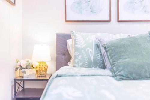 a bedroom with a bed and a table with a lamp at 3BR, 1BA House Blocks from ETSU and Downtown in Johnson City