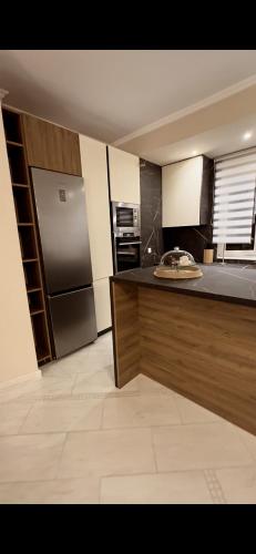 a kitchen with a refrigerator and a counter top at Plex House in Tríkala