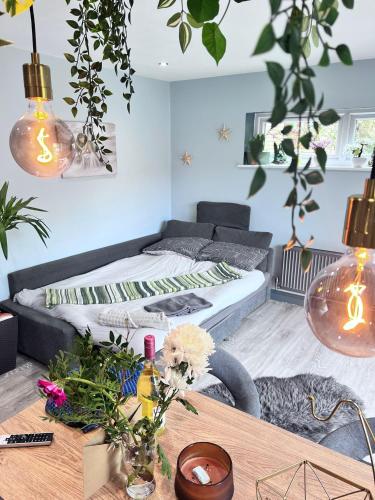 a living room with a bed and a table at Cozy Southampton Apartment Retreat in Southampton